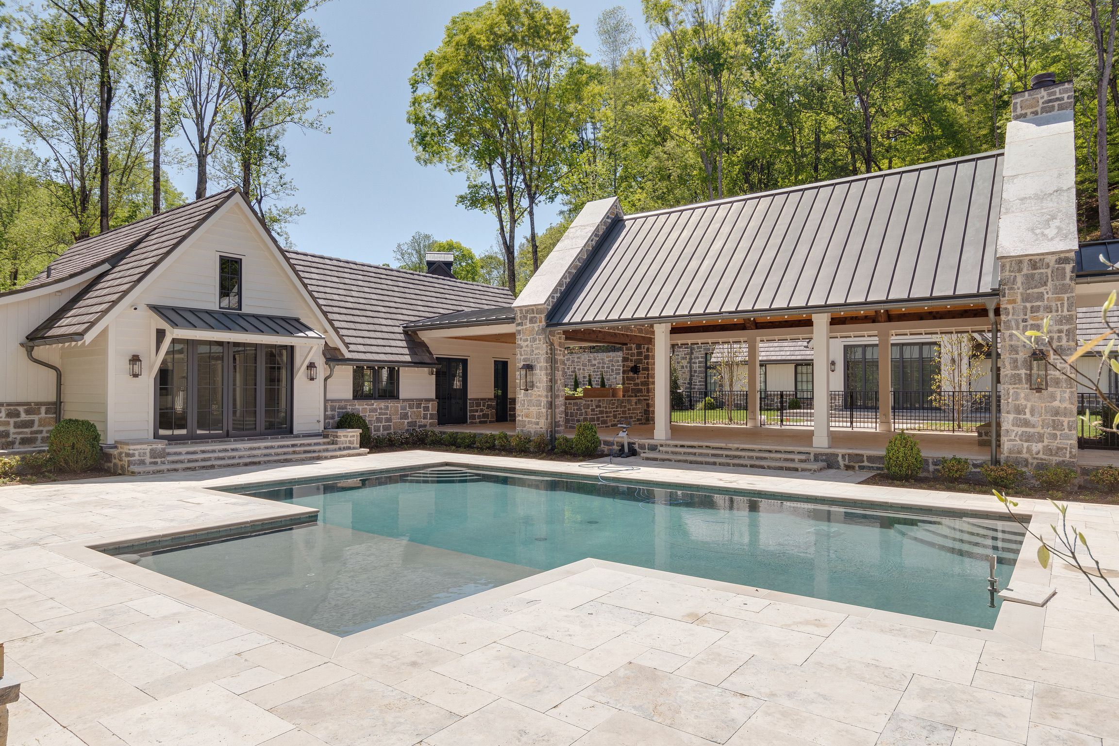 Pool area of a modern farmhouse luxury custom home built by a builder in Leipers Fork, TN
